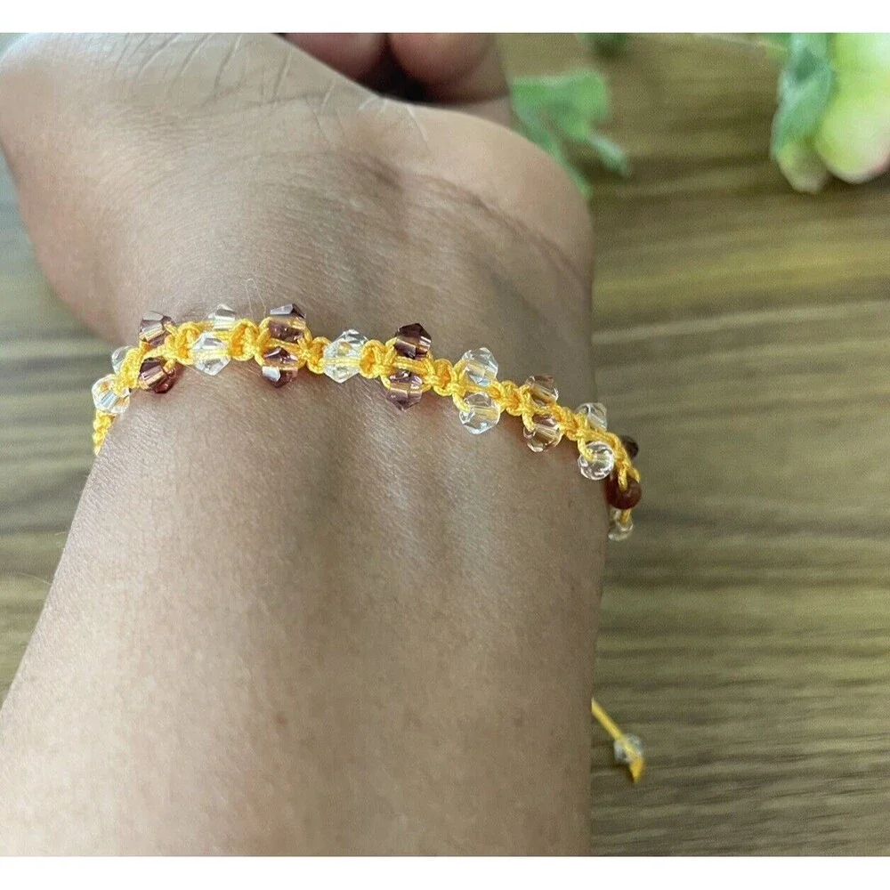 Yellow women's bracelet braided with crystals